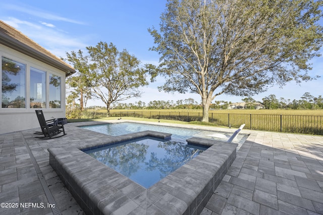 view of pool with an in ground hot tub and a patio