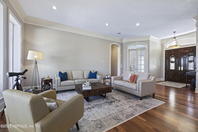 living room featuring dark hardwood / wood-style flooring and ornamental molding