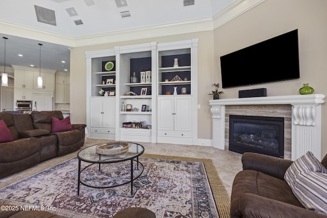 living room featuring a fireplace, built in shelves, and crown molding