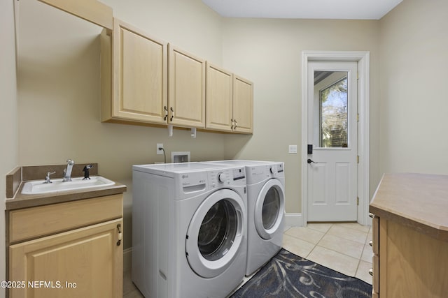 laundry room with sink, light tile patterned flooring, cabinets, and independent washer and dryer