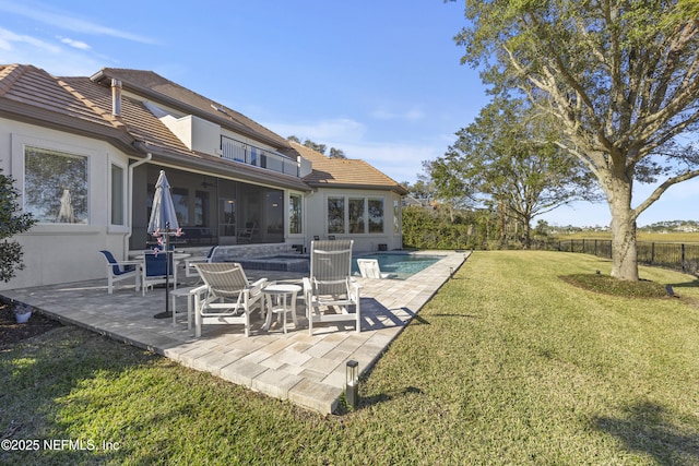 view of yard featuring a sunroom and a patio area