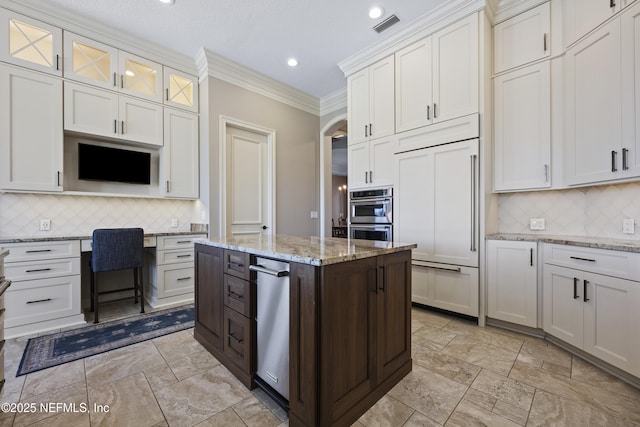 kitchen with backsplash, white cabinetry, and crown molding