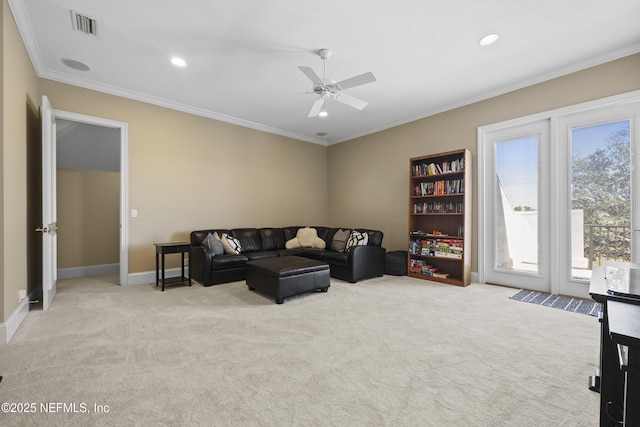 carpeted living room featuring ceiling fan and crown molding