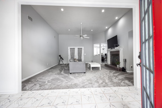 living room with ceiling fan, a high ceiling, and french doors