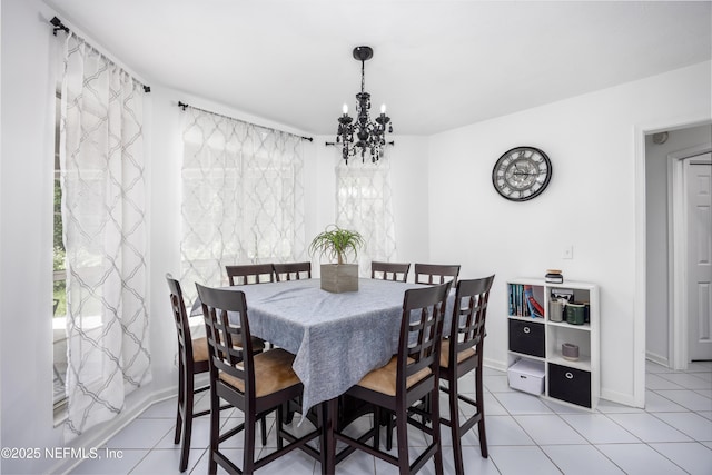 tiled dining room featuring a notable chandelier