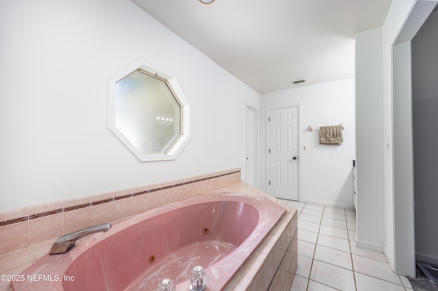 bathroom with tile patterned flooring and tiled tub