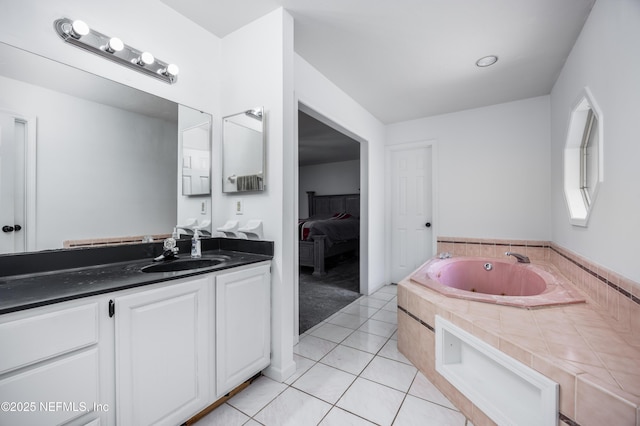 bathroom with tile patterned flooring, vanity, and a bathing tub