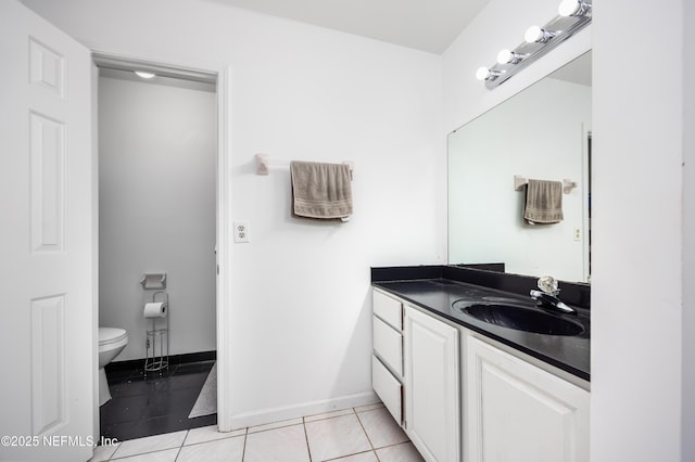 bathroom with tile patterned flooring, vanity, and toilet