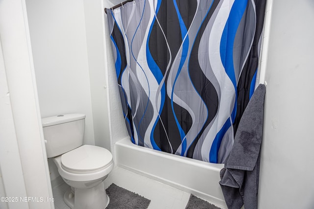 bathroom featuring shower / bath combination with curtain and toilet