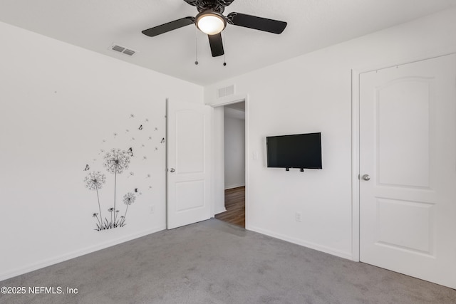 carpeted empty room with ceiling fan