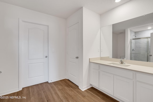 bathroom featuring vanity, hardwood / wood-style floors, and an enclosed shower