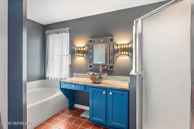 bathroom with shower with separate bathtub, tile patterned floors, and vanity