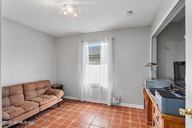 living room with tile patterned flooring and a textured ceiling