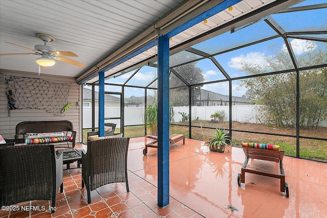 view of patio / terrace with ceiling fan, a lanai, a water view, and outdoor lounge area