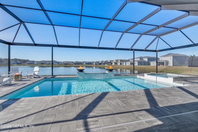 view of pool with a lanai, a patio, a water view, and an in ground hot tub