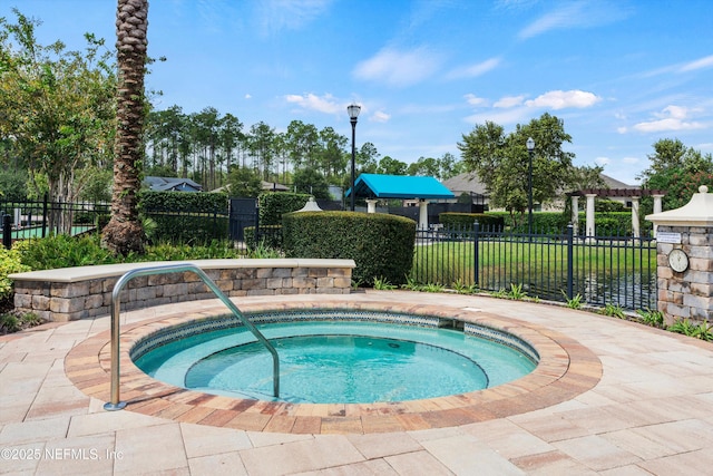 view of pool with a hot tub