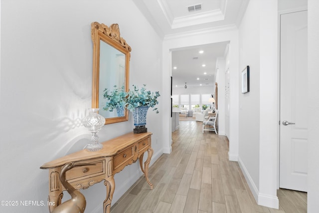 hallway featuring ornamental molding and light wood-type flooring