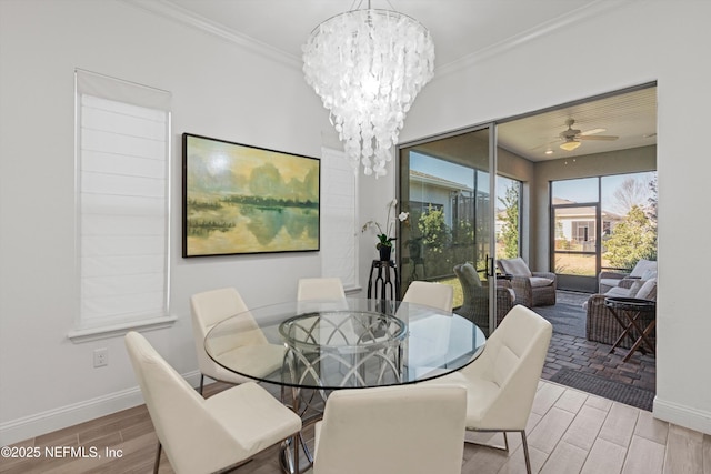 dining room with ceiling fan with notable chandelier and crown molding