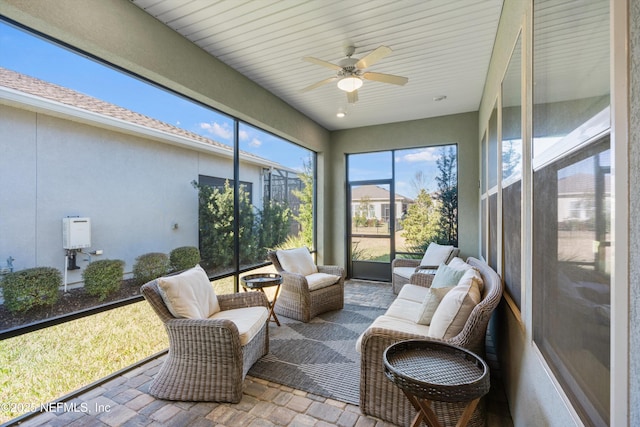 sunroom / solarium featuring ceiling fan