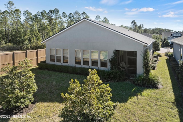 rear view of house featuring a yard