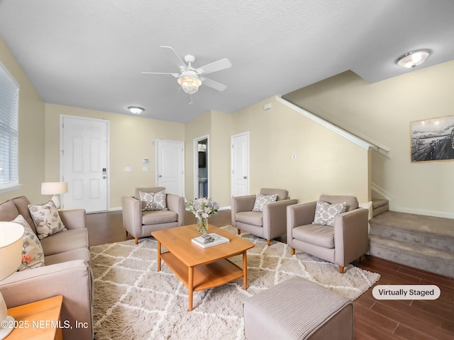 living room featuring ceiling fan and wood-type flooring