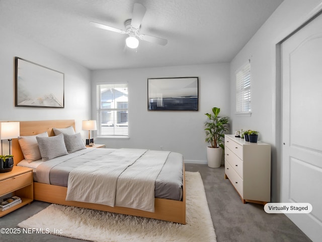 carpeted bedroom featuring ceiling fan and multiple windows