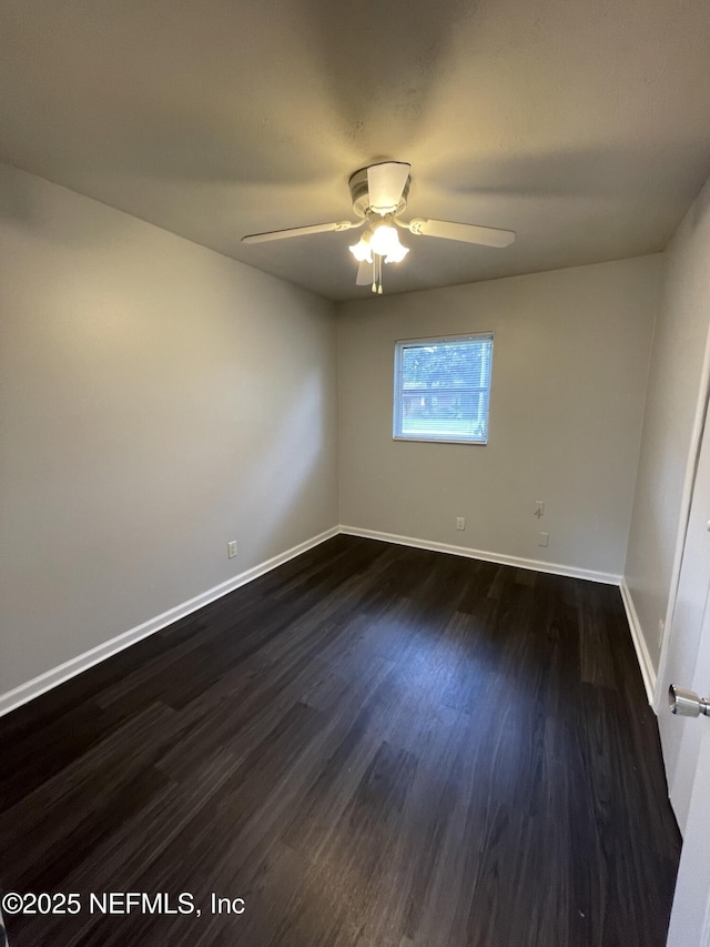 unfurnished room with dark hardwood / wood-style floors and ceiling fan