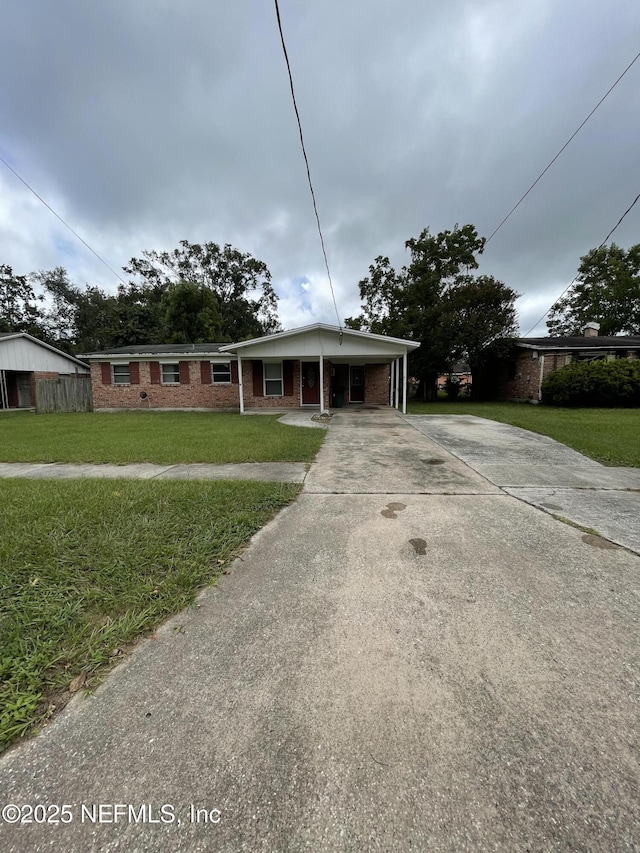 view of front facade with a carport and a front yard