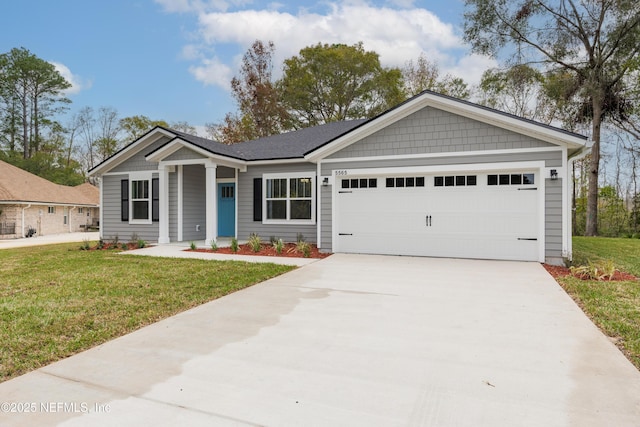 view of front of home featuring a garage and a front lawn