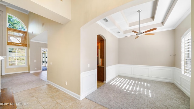 unfurnished room with light colored carpet, ceiling fan, and ornamental molding