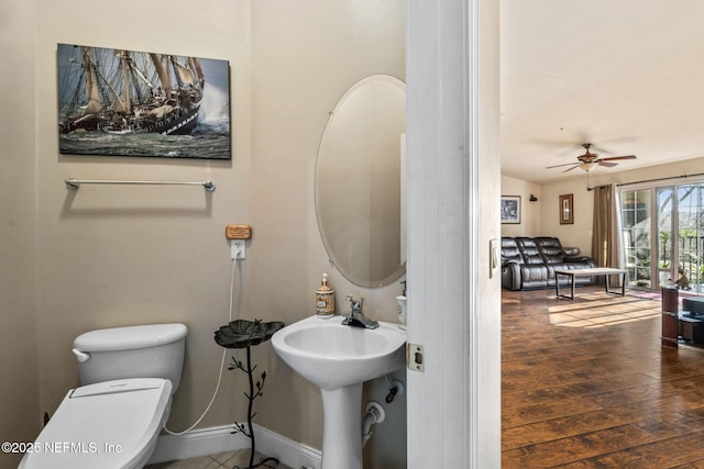 bathroom featuring hardwood / wood-style flooring, ceiling fan, toilet, and sink