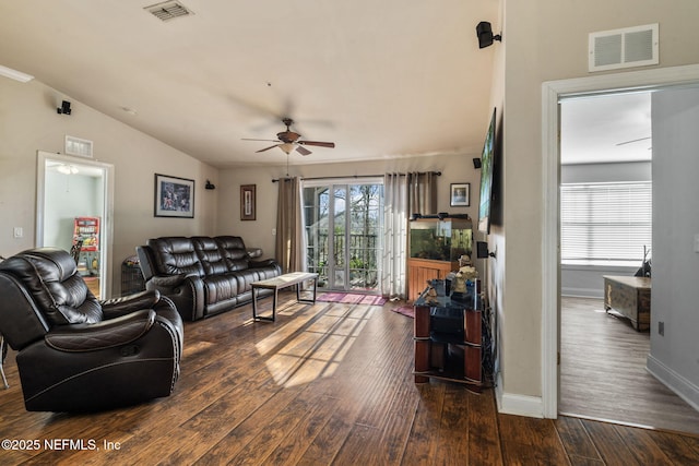 living room featuring lofted ceiling, dark wood-type flooring, and ceiling fan