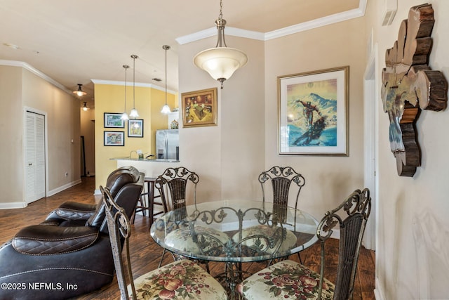 dining area with crown molding and dark hardwood / wood-style floors