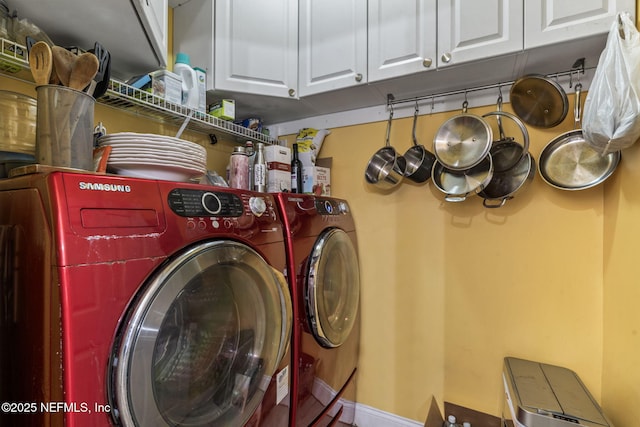 washroom featuring washer and clothes dryer and cabinets