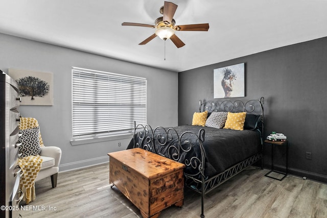 bedroom with ceiling fan and light wood-type flooring