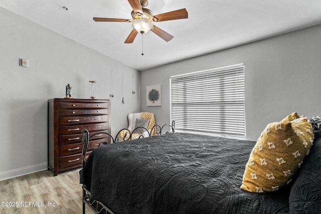 bedroom with ceiling fan and light wood-type flooring