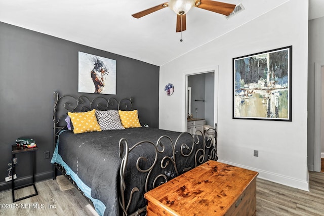 bedroom with vaulted ceiling, hardwood / wood-style floors, and ceiling fan