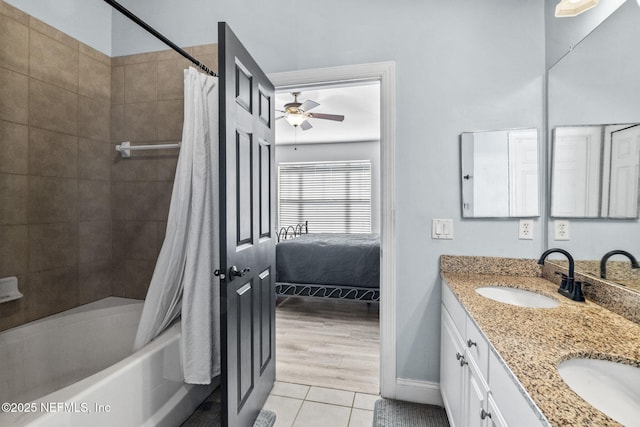 bathroom featuring tile patterned flooring, vanity, shower / tub combo, and ceiling fan