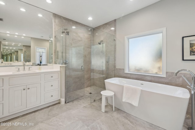 bathroom featuring vanity and separate shower and tub