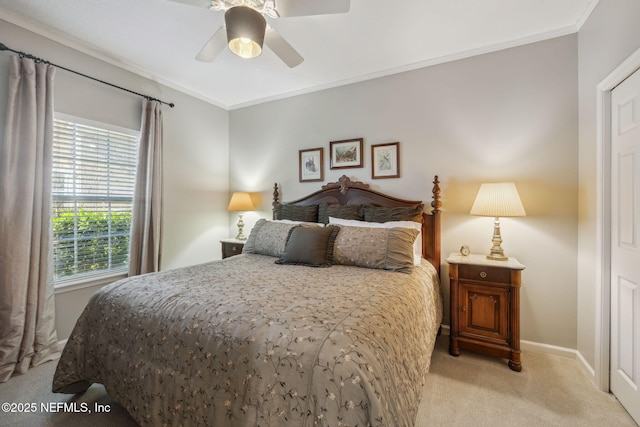 bedroom with crown molding, light colored carpet, and ceiling fan