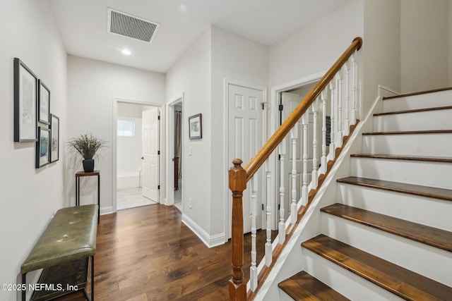 stairway with hardwood / wood-style flooring