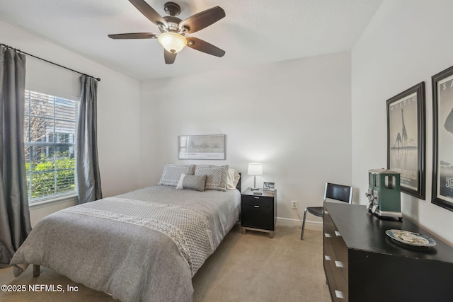 bedroom featuring light colored carpet and ceiling fan