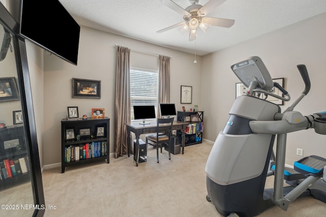 interior space featuring ceiling fan, light colored carpet, and a textured ceiling