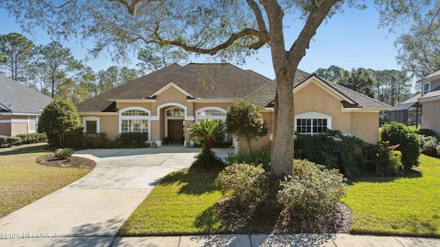 ranch-style home with a front lawn