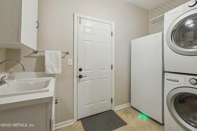 clothes washing area with stacked washer and dryer and sink