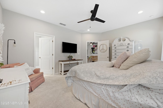 carpeted bedroom with a spacious closet and ceiling fan