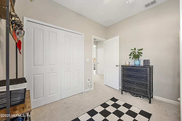 carpeted bedroom with a closet and ceiling fan