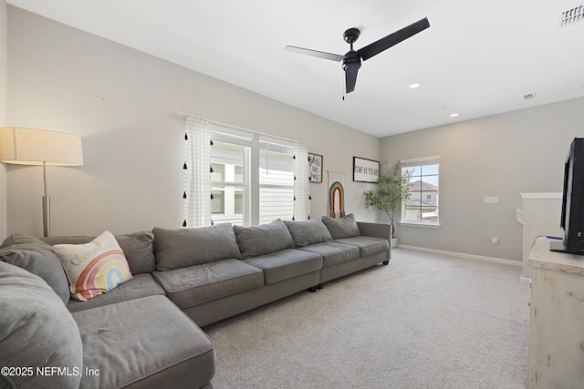 carpeted living room with ceiling fan and plenty of natural light