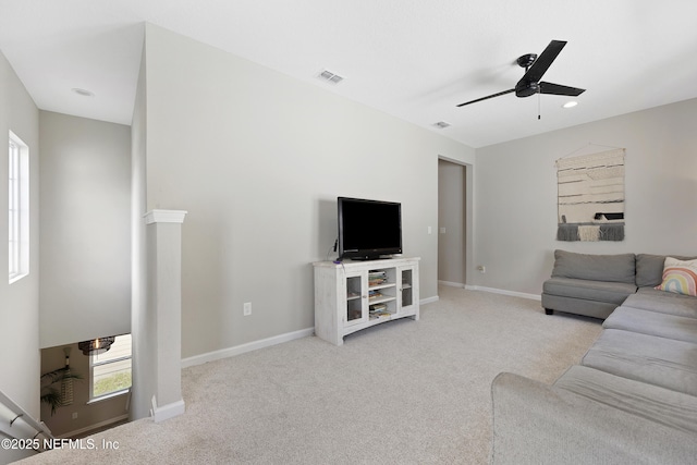 living room featuring ceiling fan and light colored carpet