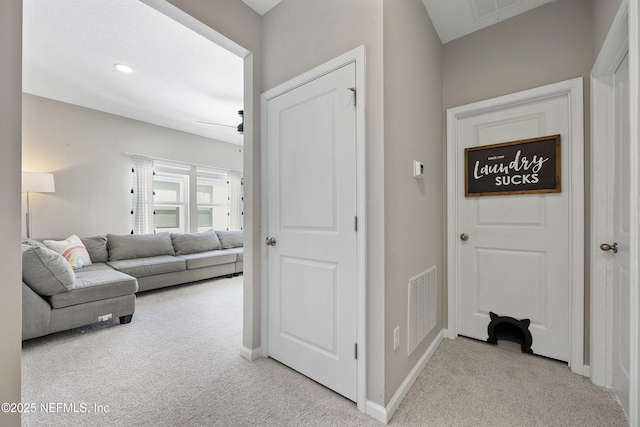 corridor with light colored carpet